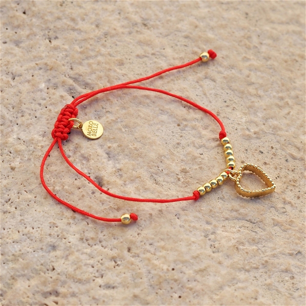 Bracelet on a red thread with a heart